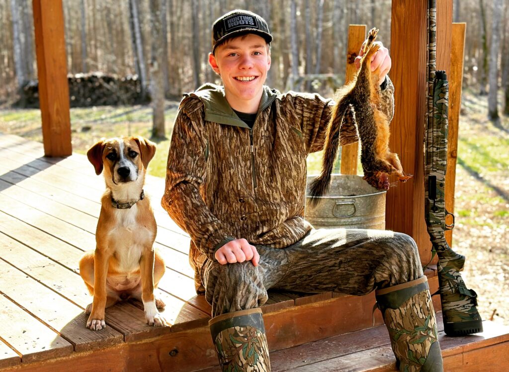young squirrel dog hunting alone in the woods